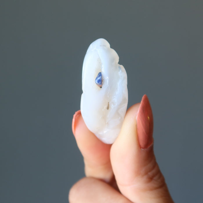 sheila of satin crystals holding an agate tumbled stone