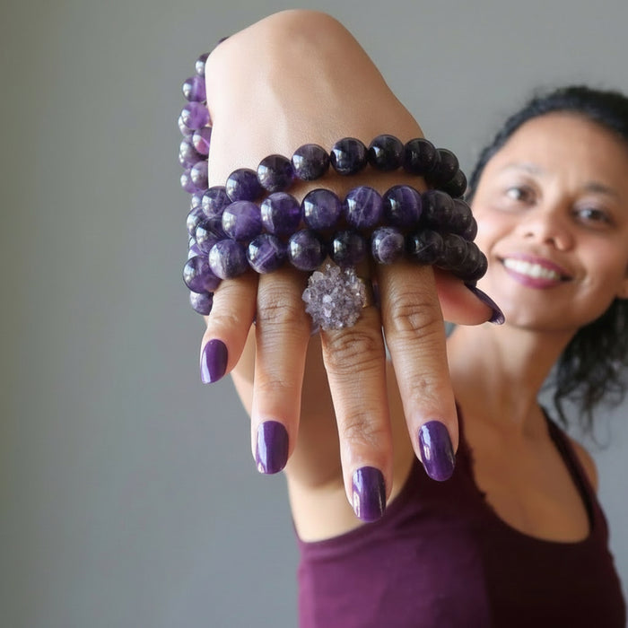 woman wearing dark amethyst bracelets and ring