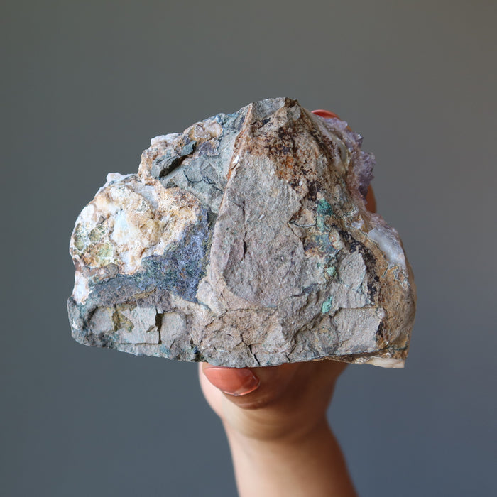 hand holding amethyst cluster geode