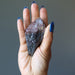 hand holding raw super 7 amethyst crystal point