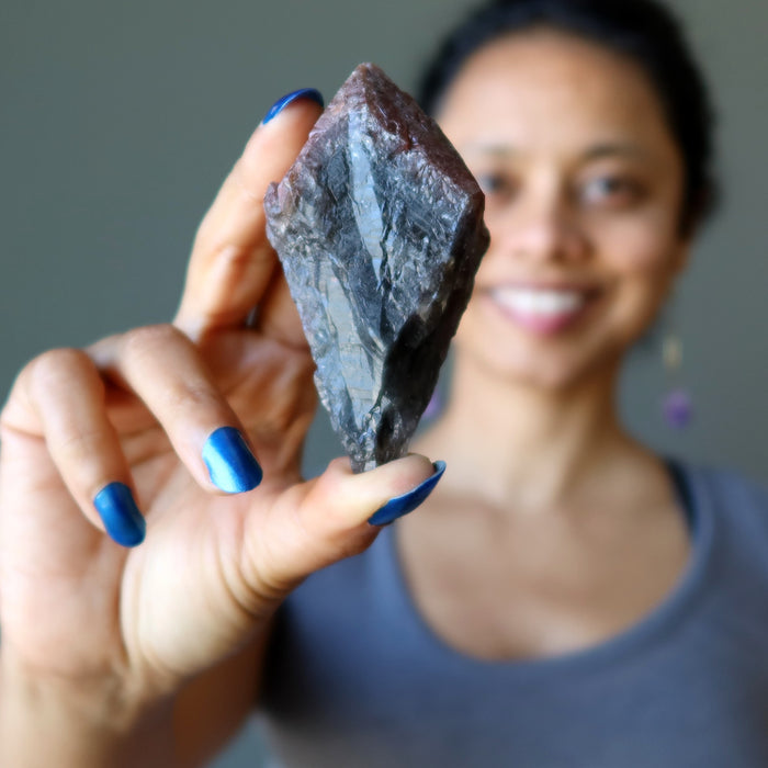 sheila of satin crystals holding raw super 7 amethyst crystal point