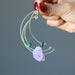 fingers holding Purple Green Gold Dangle Amethyst Malachite Earrings
