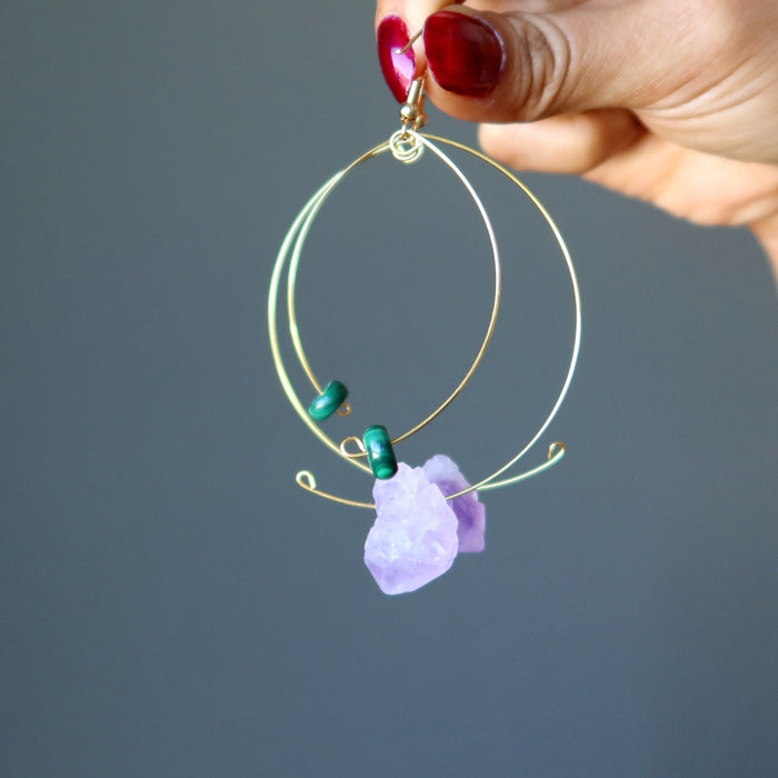 fingers holding Purple Green Gold Dangle Amethyst Malachite Earrings