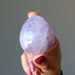 fingers holding Amethyst egg