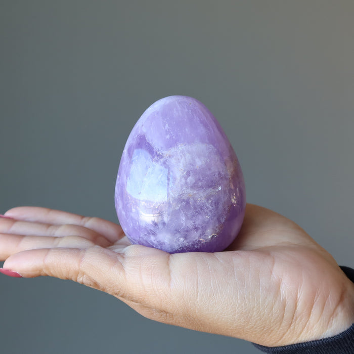 palm holding an amethyst egg