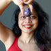 Sheila of Satin Crystals holding dark purple amethyst gemstone egg