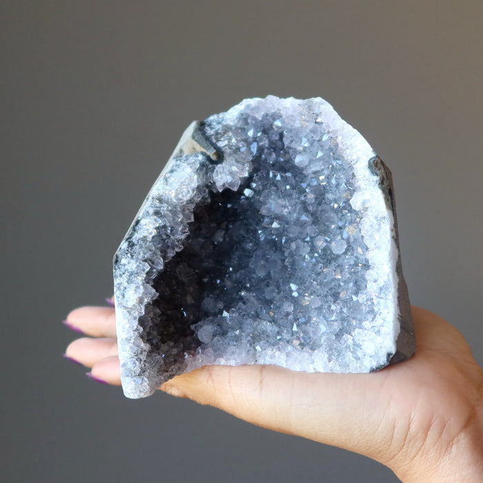 woman holding amethyst geode
