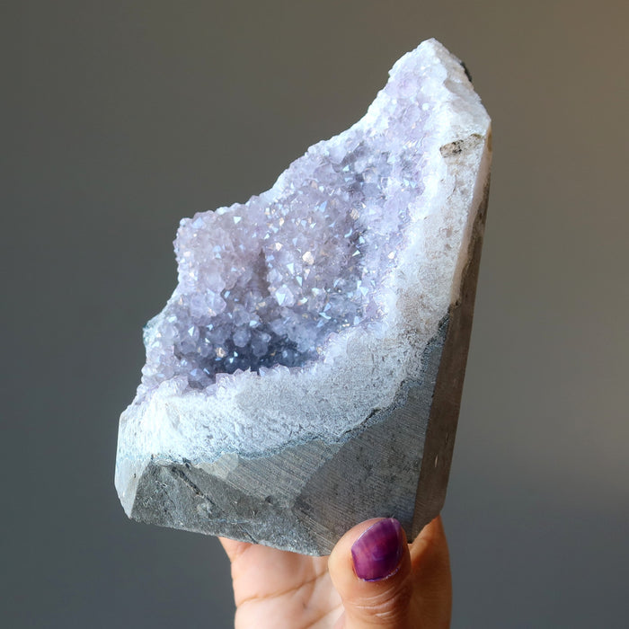 woman holding amethyst geode