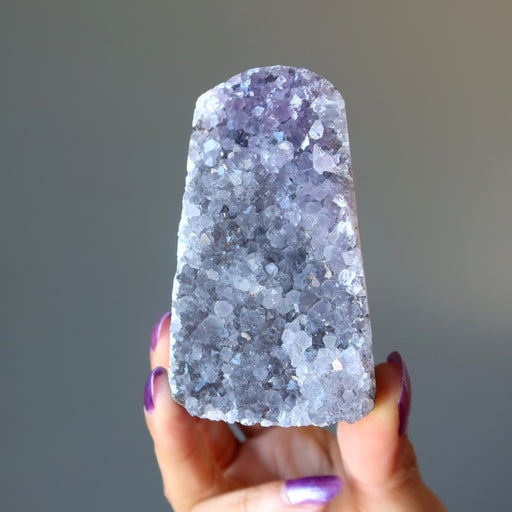 woman holding amethyst geode