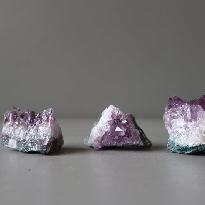 three amethyst geode clusters