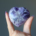 hand holding amethyst heart