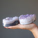 hand holding two 3.0-3.75 Inches violet amethyst heart crystal clusters