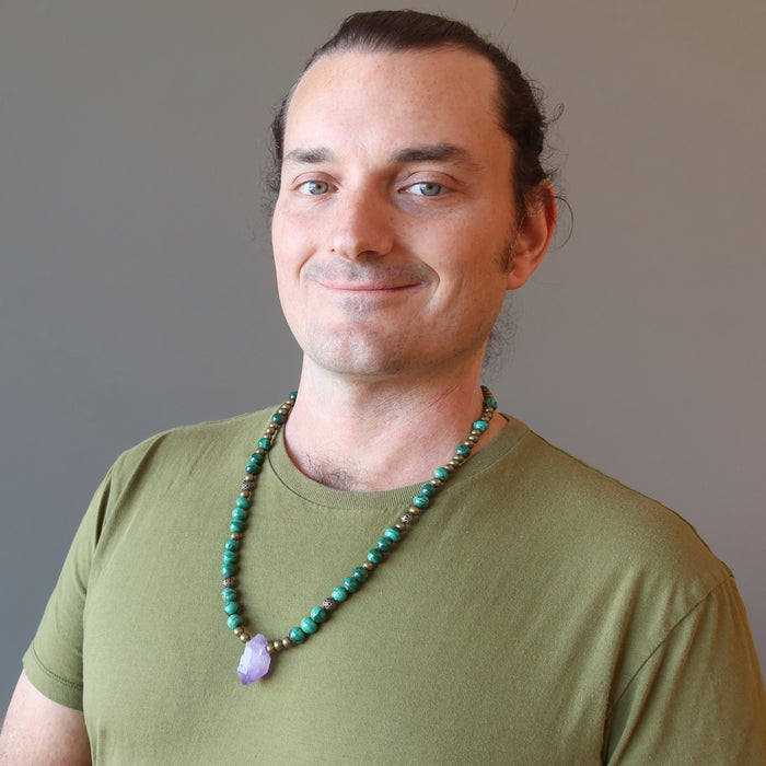 a male model wearing raw amethyst malachite beaded necklace