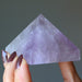 hand holding light purple amethyst pyramid