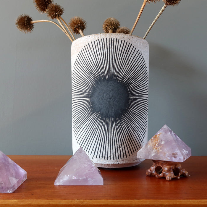 three amethyst pyramids on display