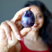 Sheila of Satin Crystals holding dark purple amethyst gemstone egg
