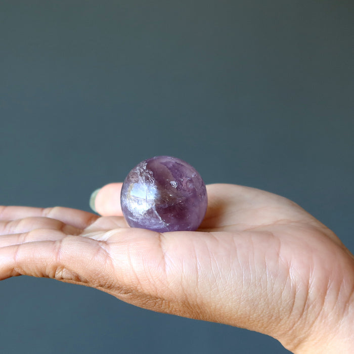 ametrine sphere in hand