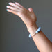 female hand modeling angelite brass stretch bracelet
