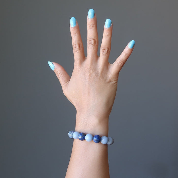 female hand wearing lapis angelite bracelet