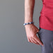 male hand in pocket wearing lapis angelite bracelet
