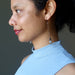 sheila of satin crystal wearing angelite Hopi bean and wood bead dangling earrings