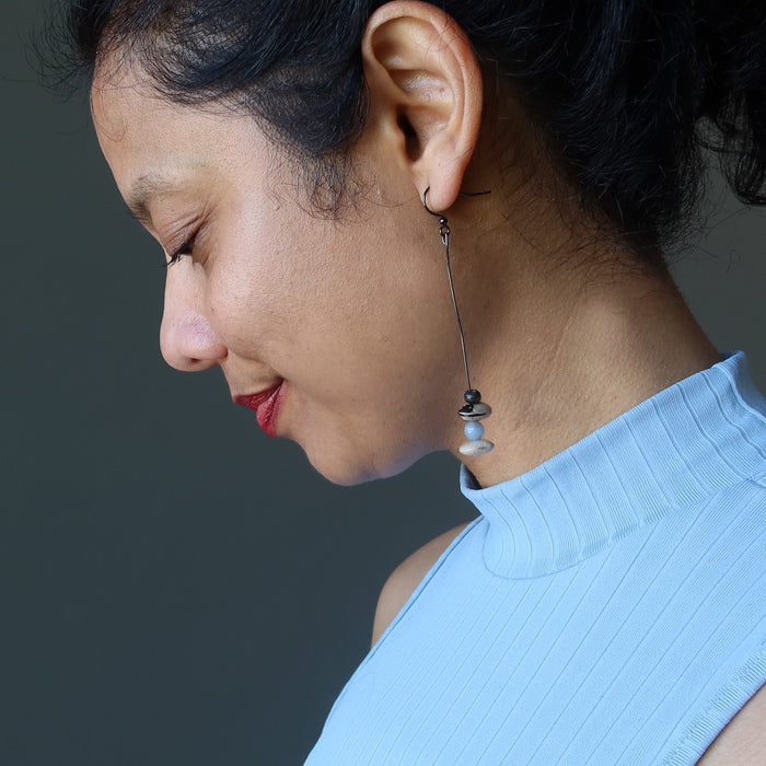 sheila of satin crystal wearing angelite Hopi bean and wood bead dangling earrings