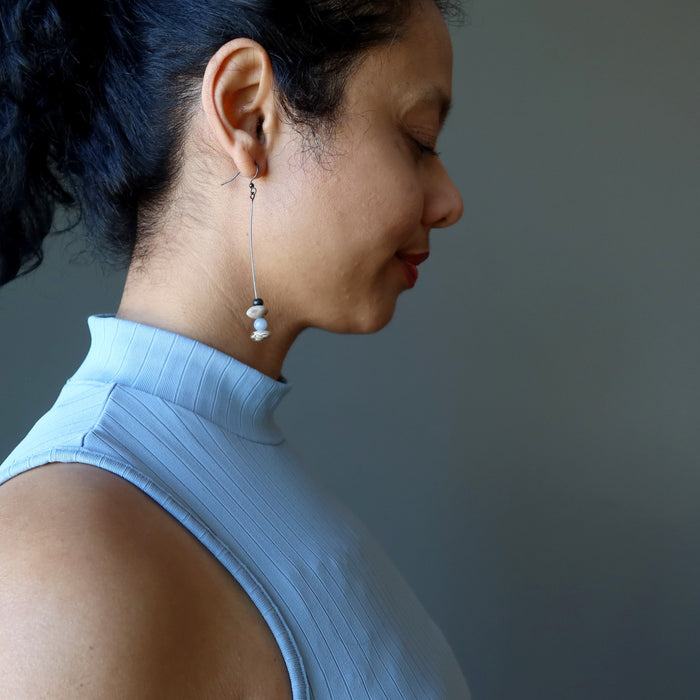 sheila of satin crystal wearing angelite Hopi bean and wood bead dangling earrings