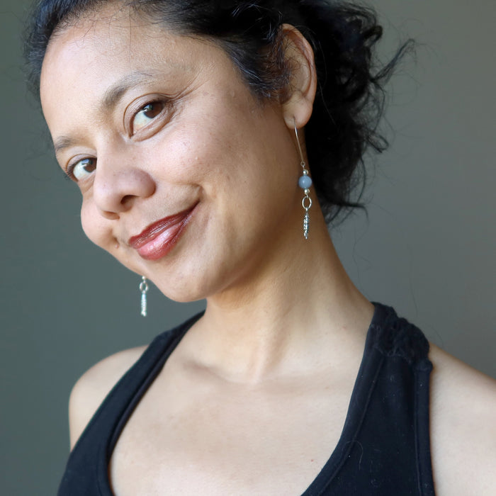 sheila of satin crystals wearing blue angelite fish earrings