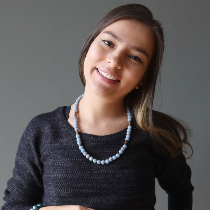 woman wearing a blue angelite necklace