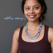 woman wearing a beaded angelite necklace and earrings