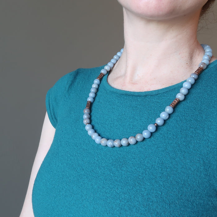 woman wearing a beaded angelite necklace