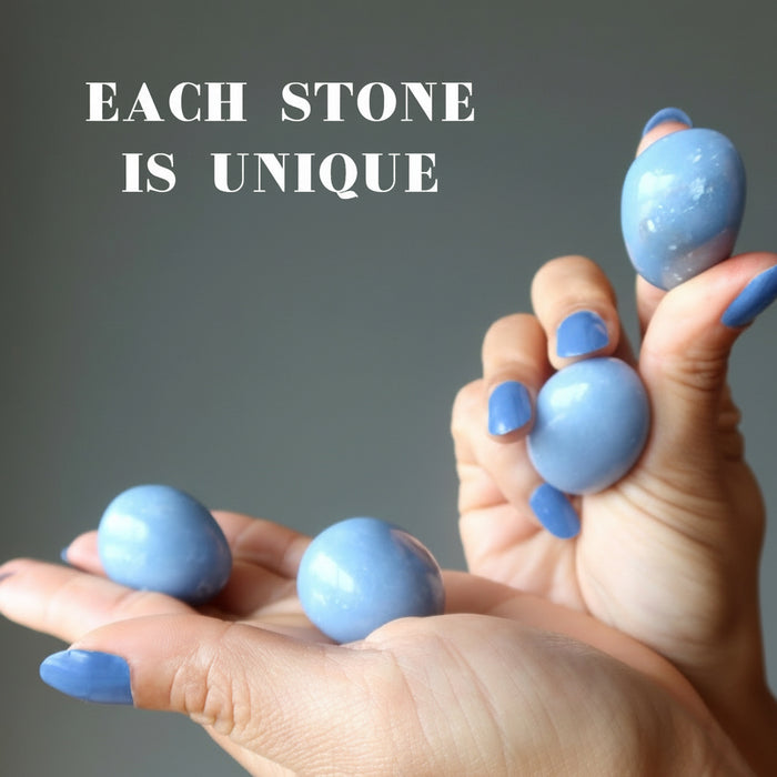 two hands holding angelite tumbled stone pairs