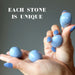 two hands holding angelite tumbled stone pairs