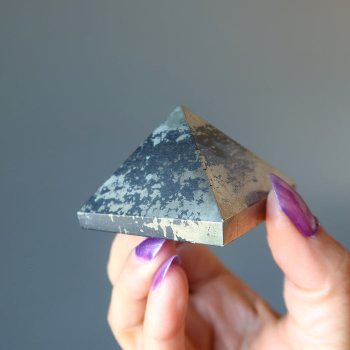 hand holding apache gold pyramid