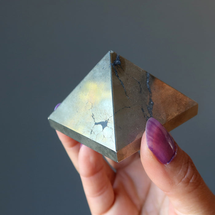 hand holding apache gold pyramid