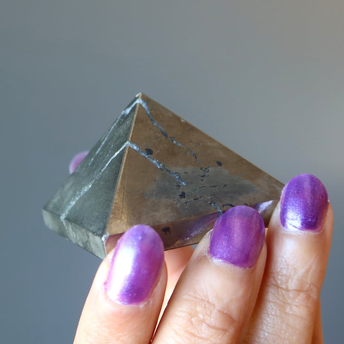 hand holding apache gold pyramid