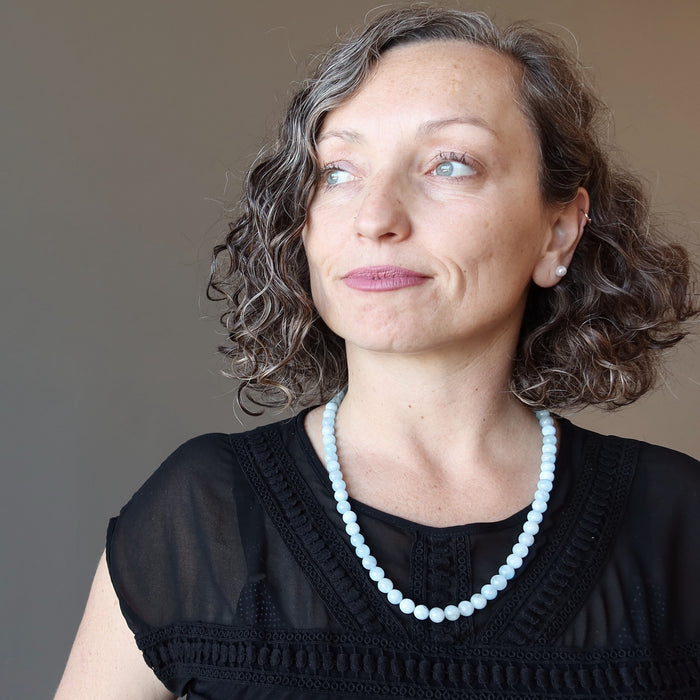 female wearing blue aquamarine necklace