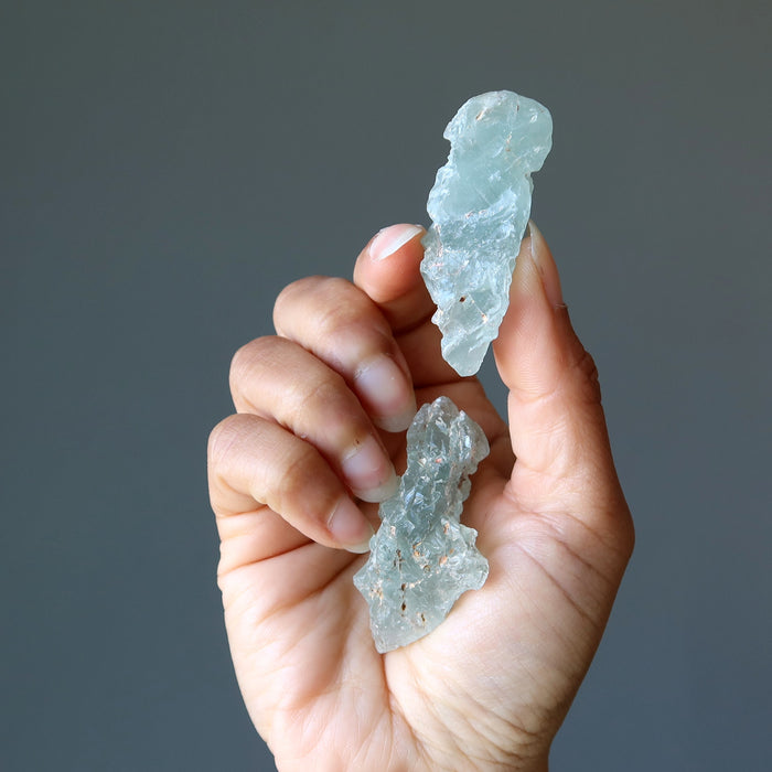 holding A Pair of Raw Aquamarine