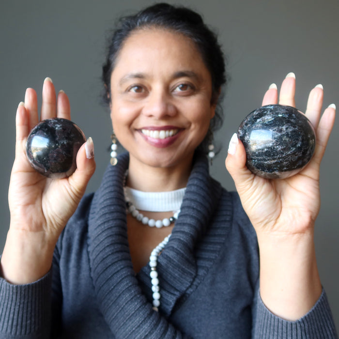 arfvedsonite garnet spheres in hands