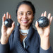 arfvedsonite garnet spheres in hands