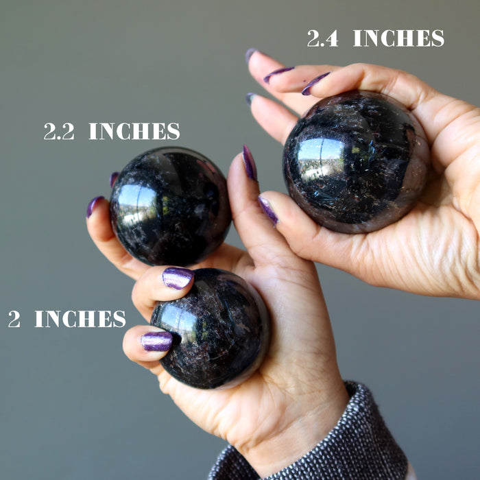 three arfvedsonite spheres to show varying sizes