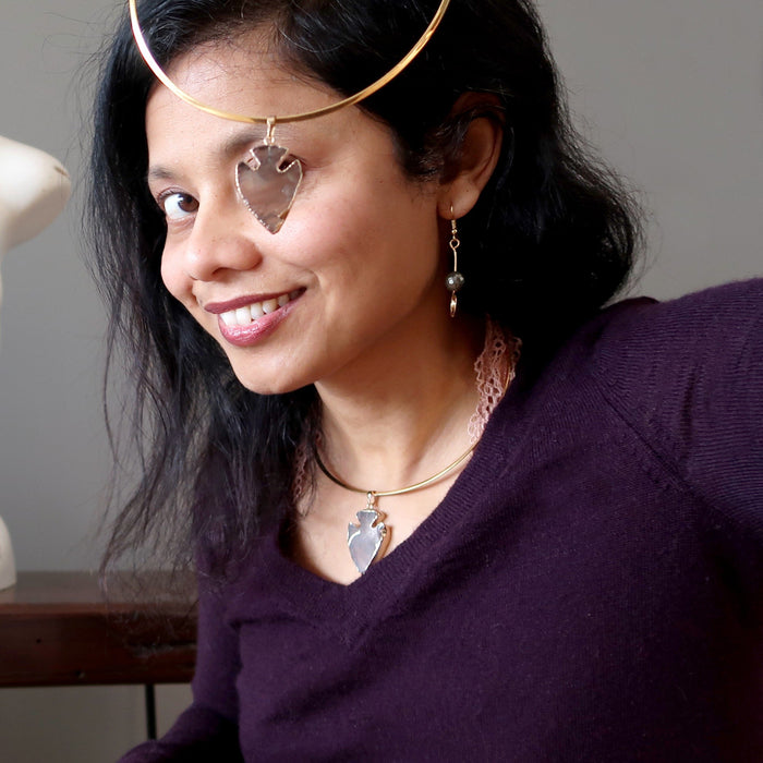 sheila of satin crystals holding a smoky quartz arrowhead necklace