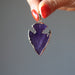holding purple Arrowhead gold plated framed Amethyst Pendant