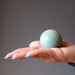 palm of hand in green aventurine crystal ball