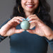 holding a green aventurine crystal ball