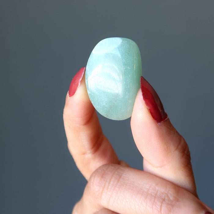 hand holding green aventurine stone