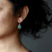 female wearing green aventurine sterling silver earrings