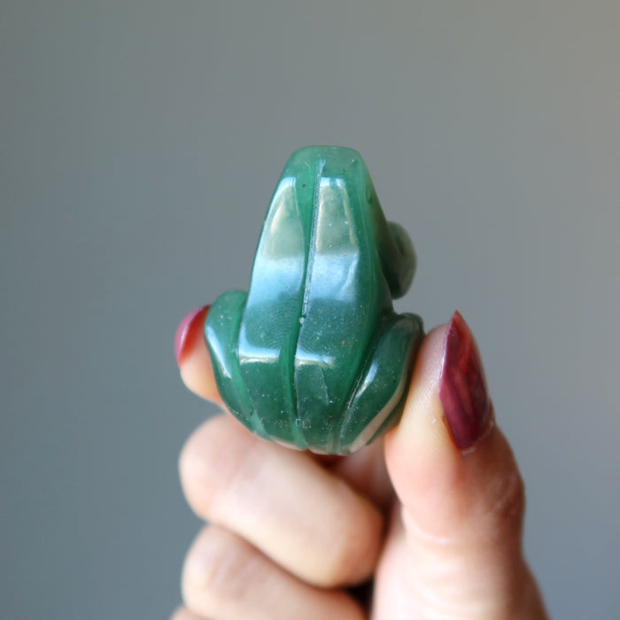 hand holding Green Aventurine Frog Statue  