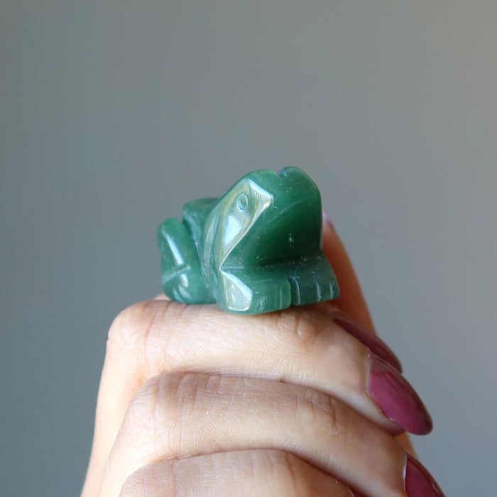hand holding Green Aventurine Frog Statue  