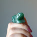 hand holding Green Aventurine Frog Statue  